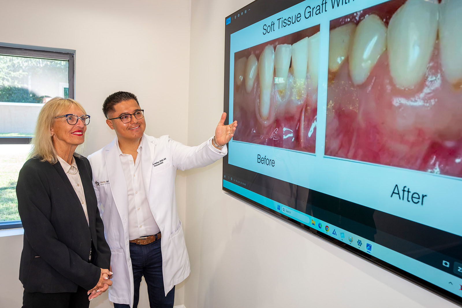 Dr. Molina shows a patient a before/after image on a TV screen