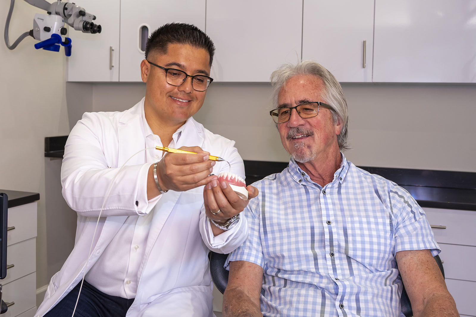 Dr. Molina showing a patient a procedure using a tool