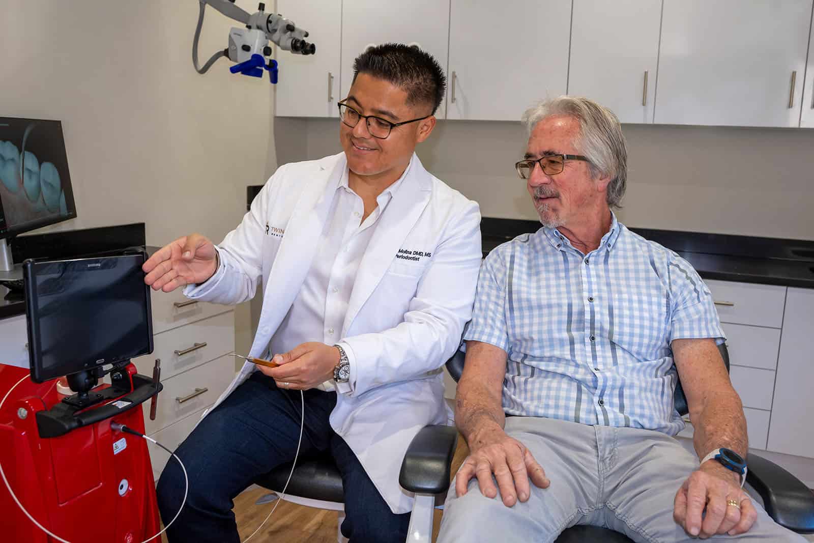 Dr. Molina showing a patient a LANAP procedure