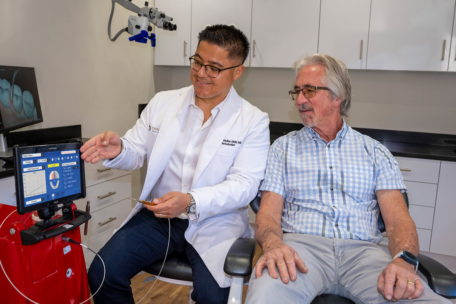 Dr. Molina showing a patient a LANAP procedure