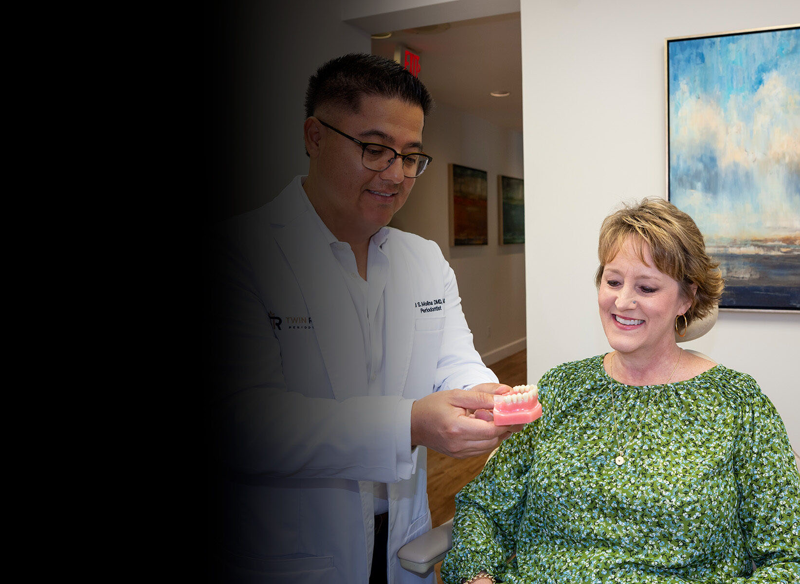 Dr. Molina showing a patient a 3D teeth model
