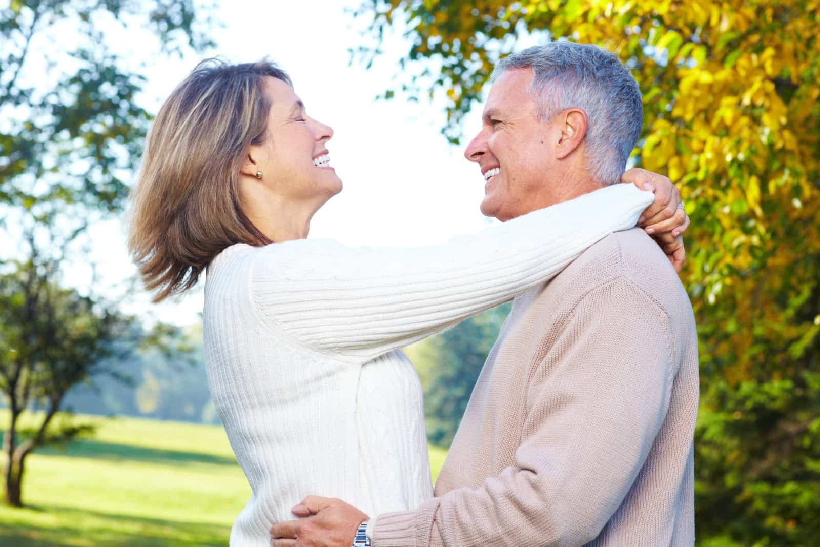 Happy elderly seniors couple in park