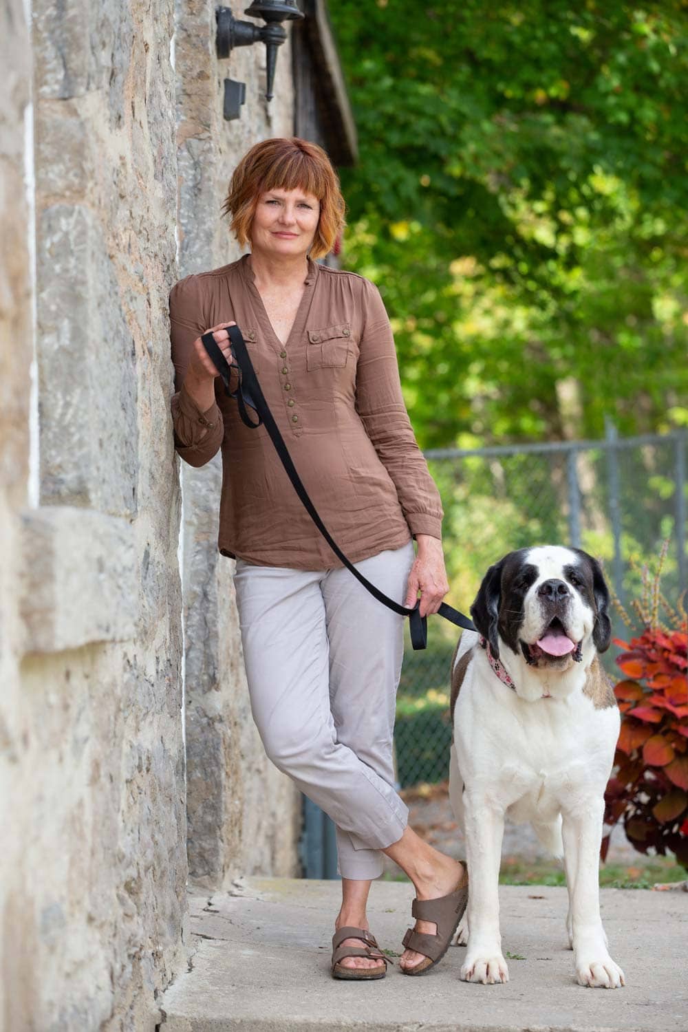 a woman photographed with her St. Bernard dog