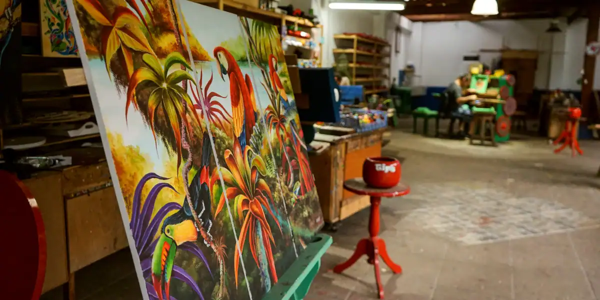 Lienzo con pintura colorida de animales y naturaleza en un taller de arte.
