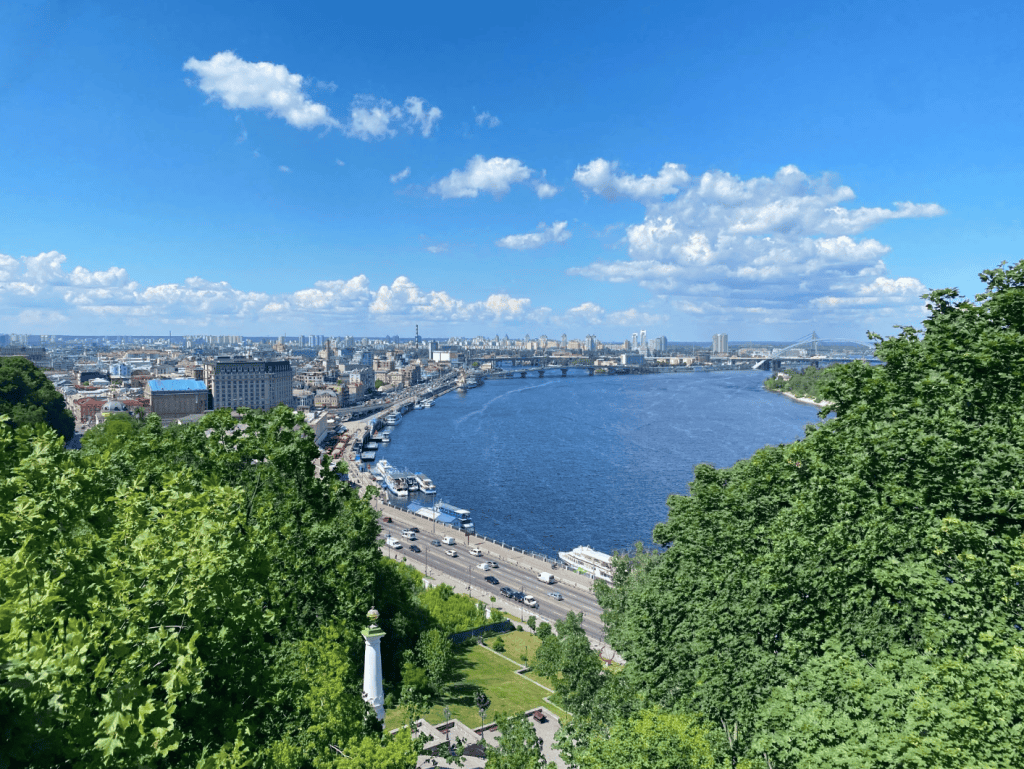 Summer Kyiv: blue sky over the Dnieper and green slopes of the capital.