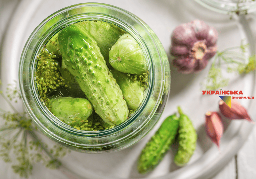 A stack of herbs and spices in a jar with cucumbers