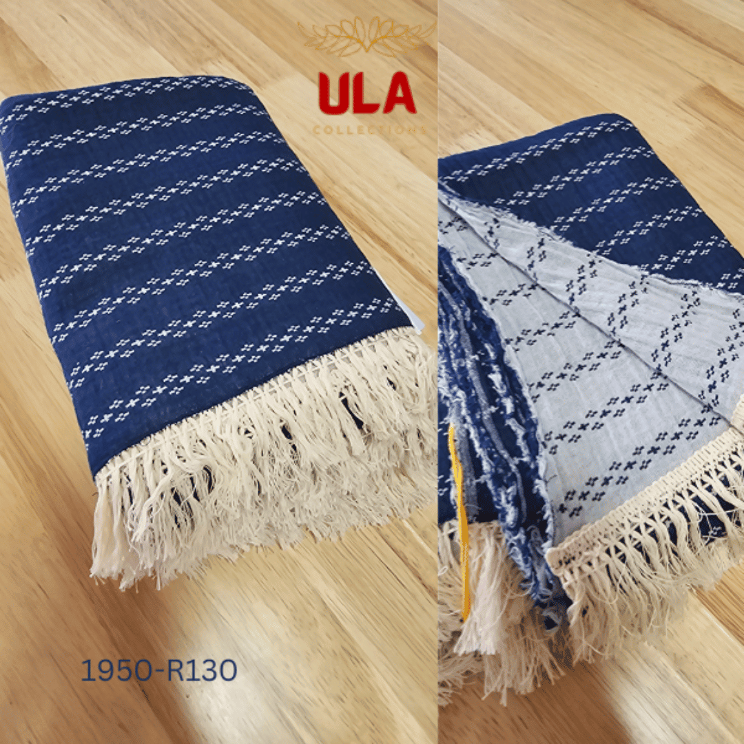 A large navy blue woven throw blanket or textile featuring a repeating pattern of thin white horizontal stripes composed of small, connected diamond or dash motifs.