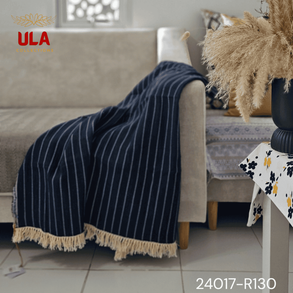 A split image showing a navy blue woven throw blanket or table runner with a vertical white pin-stripe pattern. The textile has a distressed or fringed edge and is accented with a wide, decorative cream crochet lace trim with tassels.