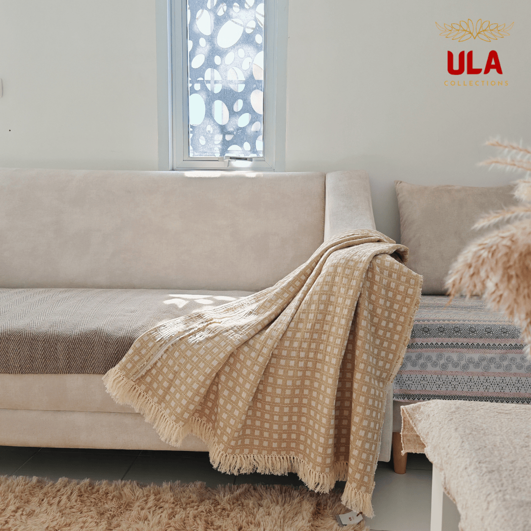 Light khaki checkered grid pattern throw blanket with fringe trim on a modern neutral sofa, minimalist home decor and soft furniture wrap by ULA Collections.