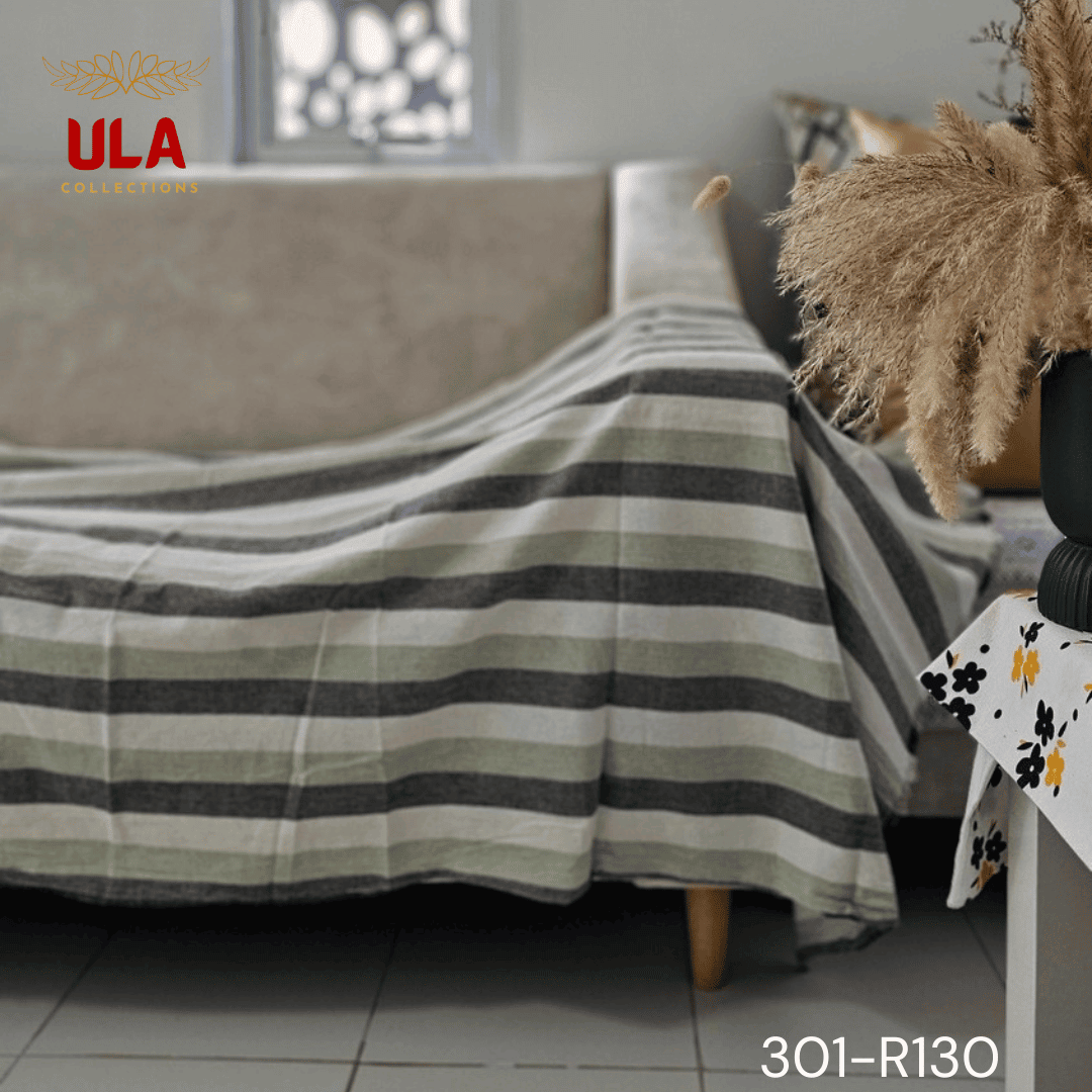 A close-up view of a soft woven throw blanket or textile featuring a bold vertical stripe pattern in a neutral and muted color scheme of charcoal gray, light sage green, and off-white.