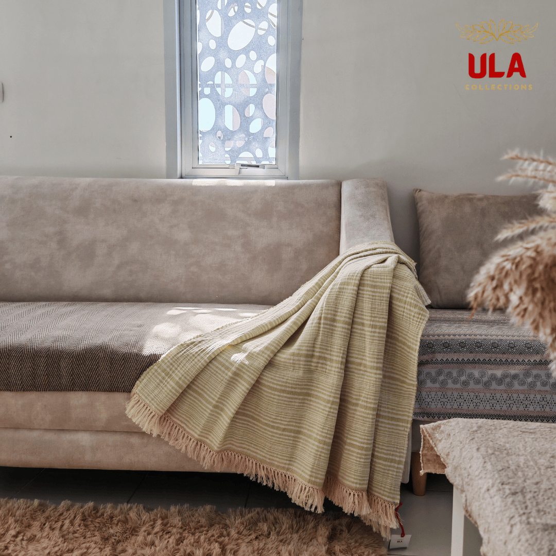 Light moss green striped textured cotton throw blanket with tassel trim, refreshing spring-themed living room decor and breathable blanket by ULA Collections.