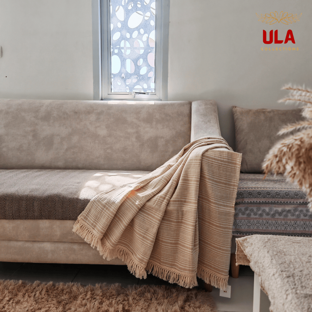 Natural khaki and cream striped cotton throw blanket with fringe, neutral farmhouse style sofa accessory and cozy home textile by ULA Collections.
