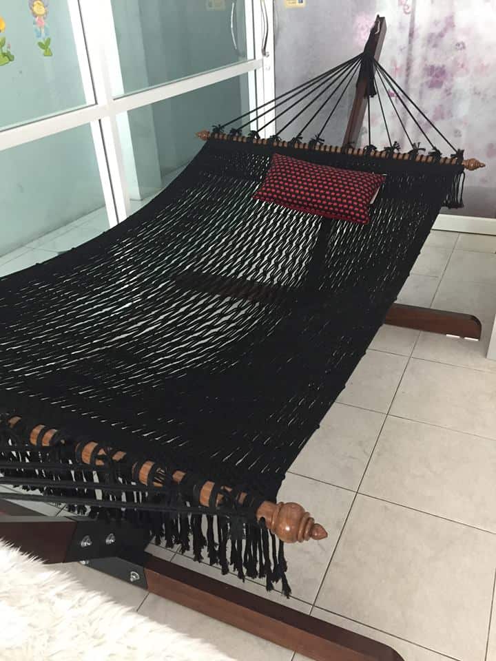 black rope hammock with wooden stand indoor