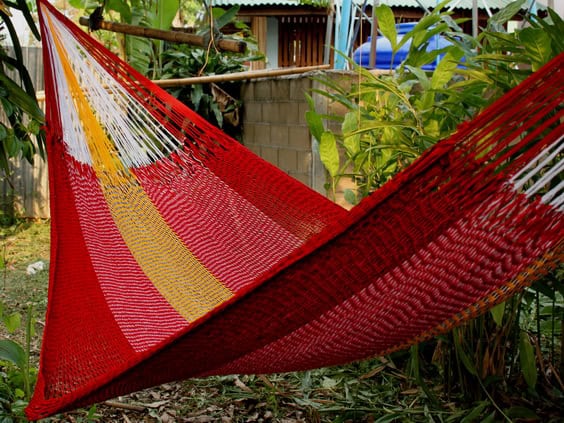Woven net hammock chair, "Rafflesia" pattern, with a deep red base contrasted by thick vertical stripes of white and beige/gold, offering a rich, elegant look.