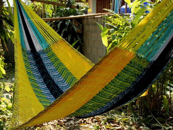 ULA "The Beach" hanging hammock chair in bright yellow, electric blue, and black stripes, using a durable weave in a vibrant, nautical-inspired color palette.
