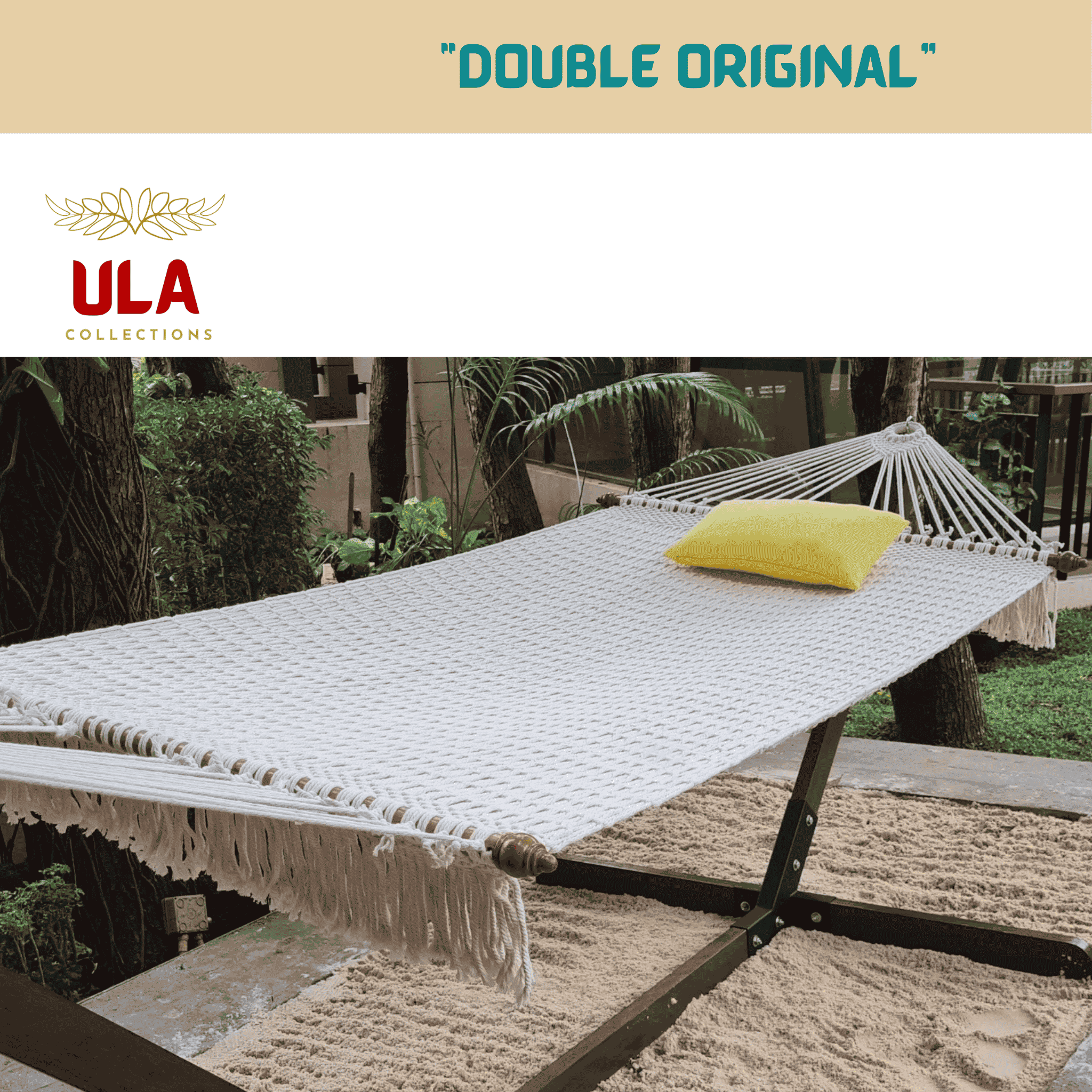 Double Original white woven rope hammock and wooden stand with a yellow pillow in a tropical garden.