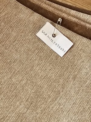 Solid light tan or beige **woven upholstery fabric** with a subtle texture