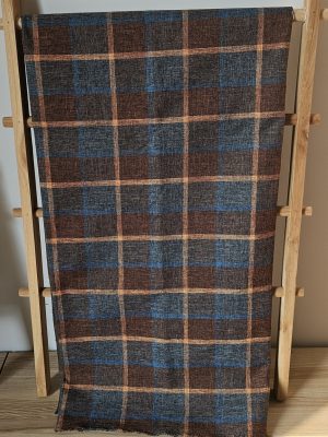 Rustic **plaid woven upholstery fabric** in brown, blue, and gold tones