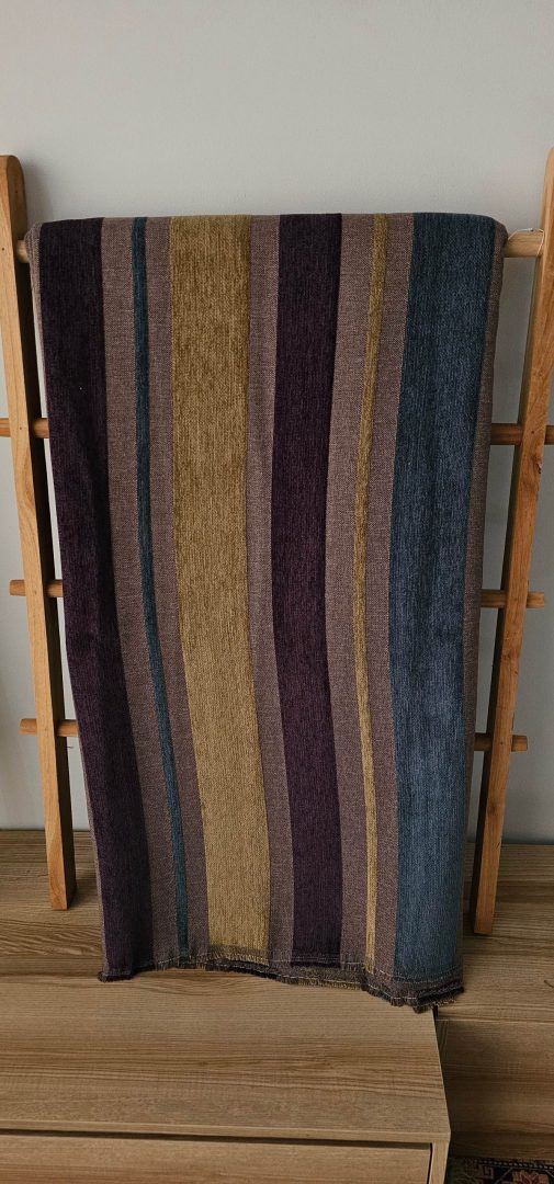 Striped woven upholstery fabric with blue, purple, brown, and gold colors