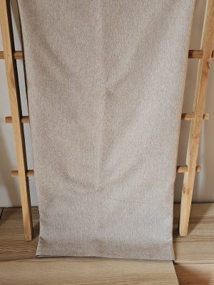 Solid light tan or beige **woven upholstery fabric** with a subtle texture