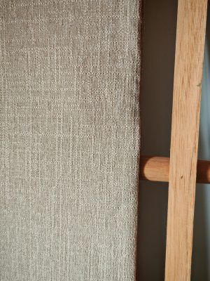Close-up showing the texture of thick cotton linen fabric in a natural beige or light brown color.