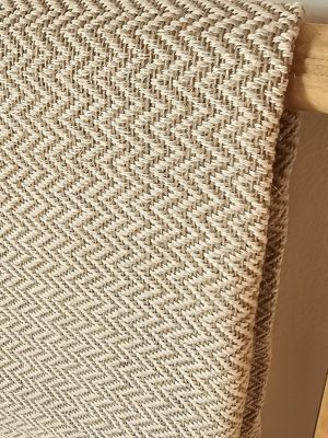 Neutral beige and cream woven **herringbone** patterned upholstery **fabric**