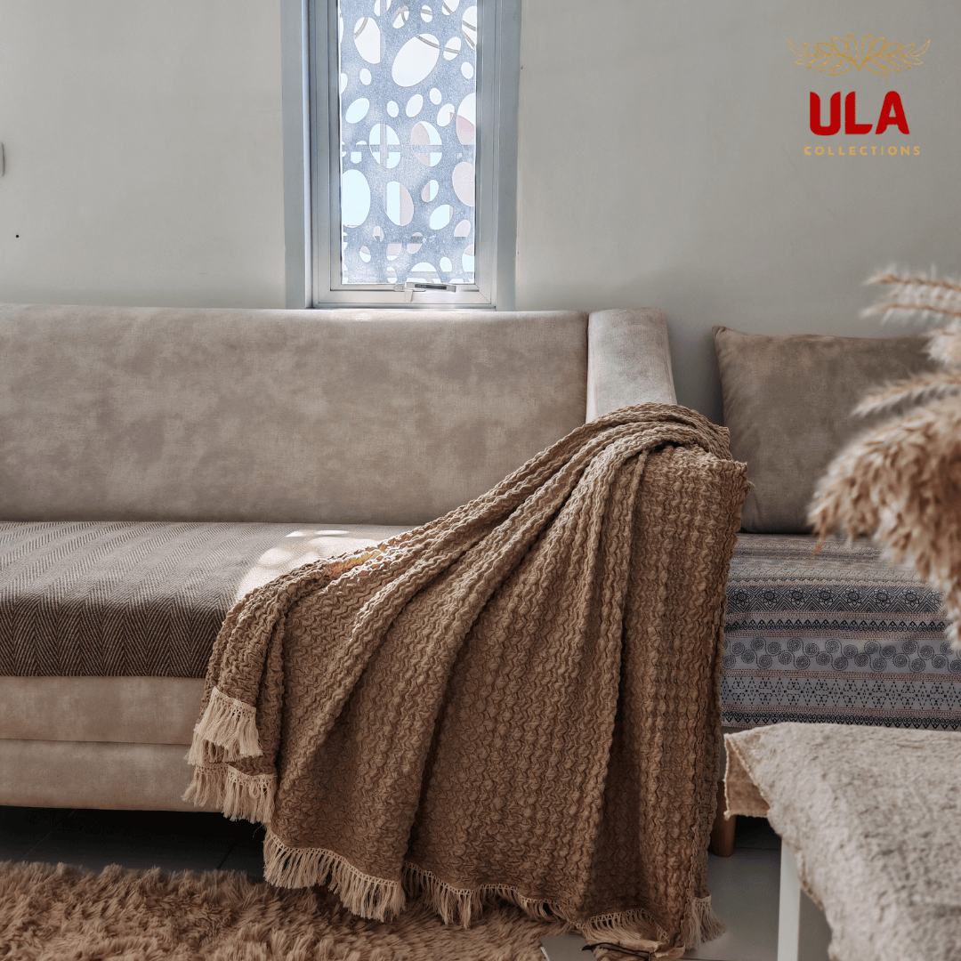 Warm almond brown Ruffle waffle-knit throw blanket with decorative tassel edges, cozy earth-tone home accessories for modern interiors by ULA Collections.