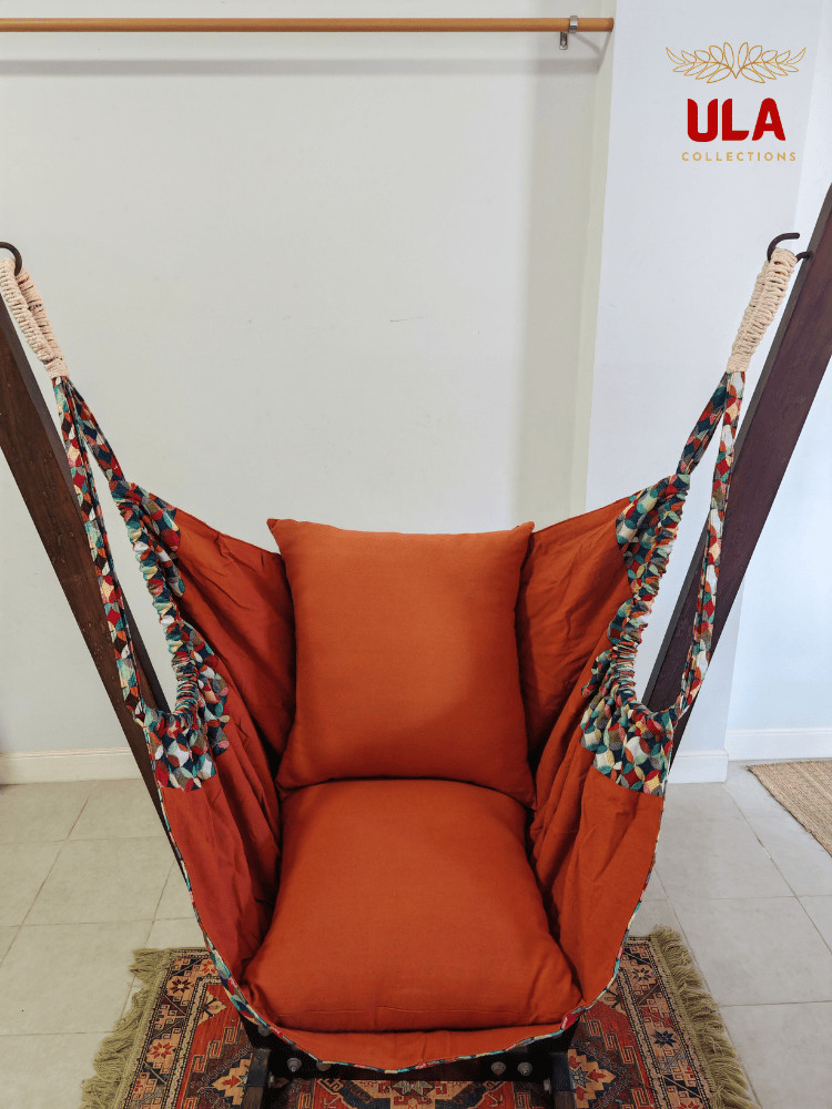 Vibrant woven fabric hammock chair featuring the Canyon multicolored overlapping circle pattern and plush orange cushions.