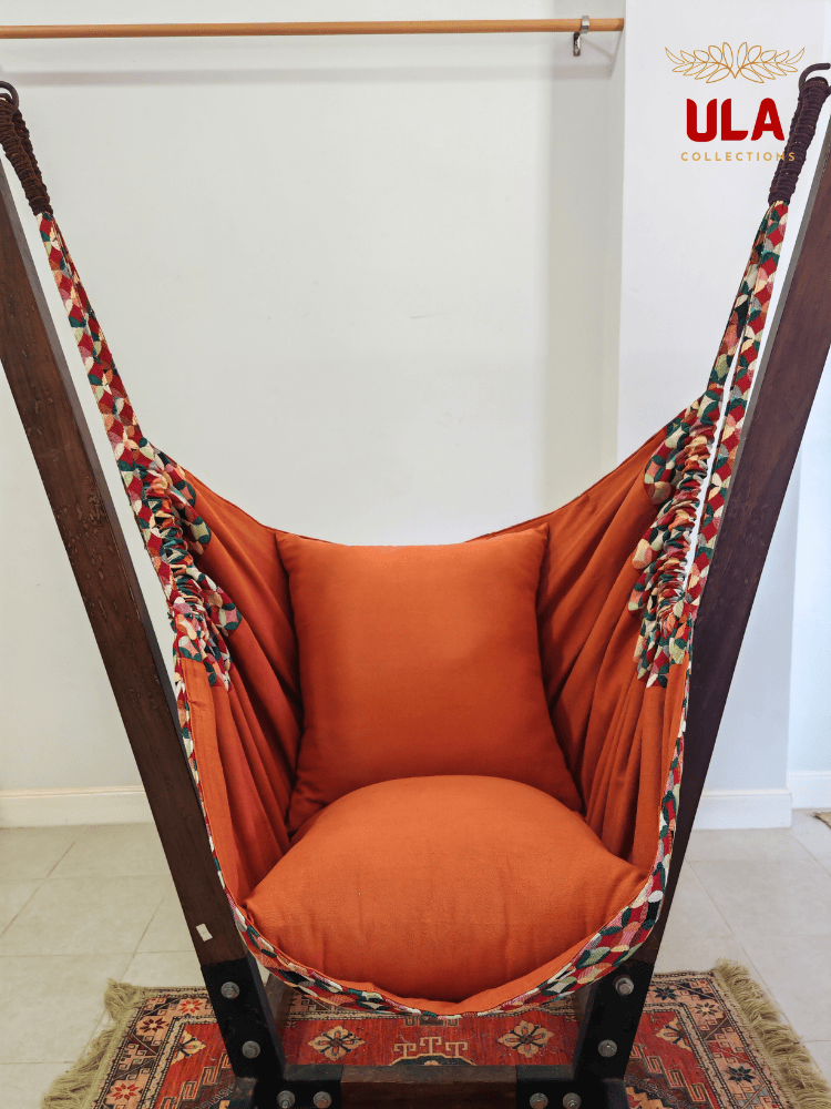 Vibrant woven fabric hammock chair featuring the Canyon multicolored overlapping circle pattern and plush orange cushions.