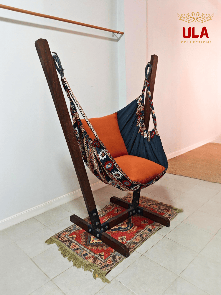 Navy and orange Native design woven hammock chair on a wooden stand