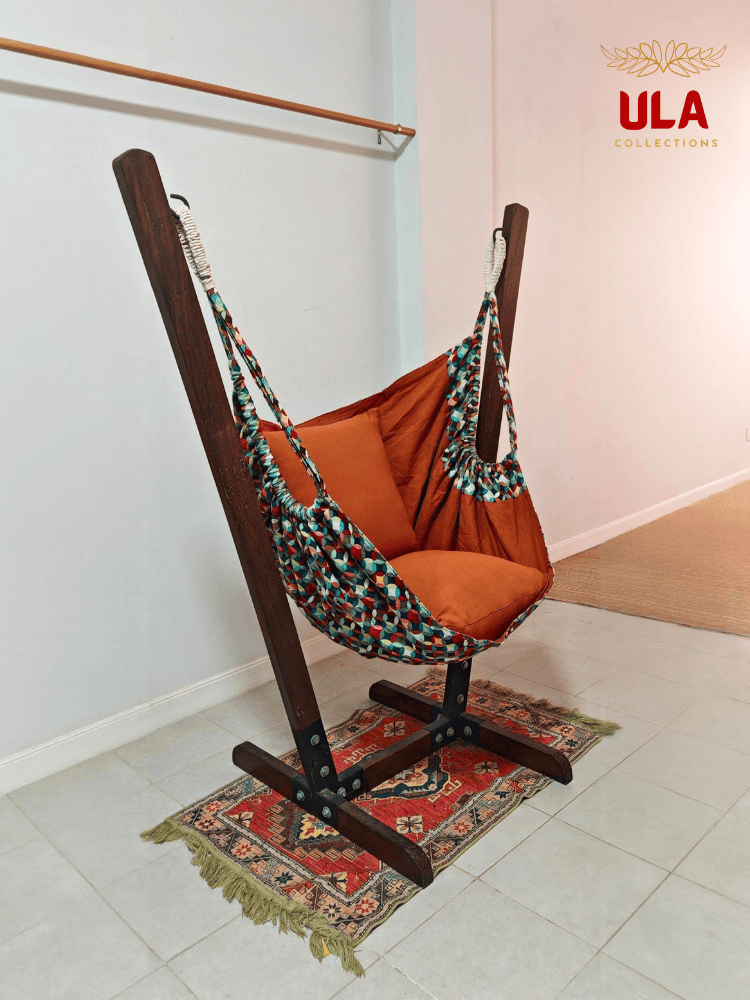 Vibrant woven fabric hammock chair featuring the Canyon multicolored overlapping circle pattern and plush orange cushions.