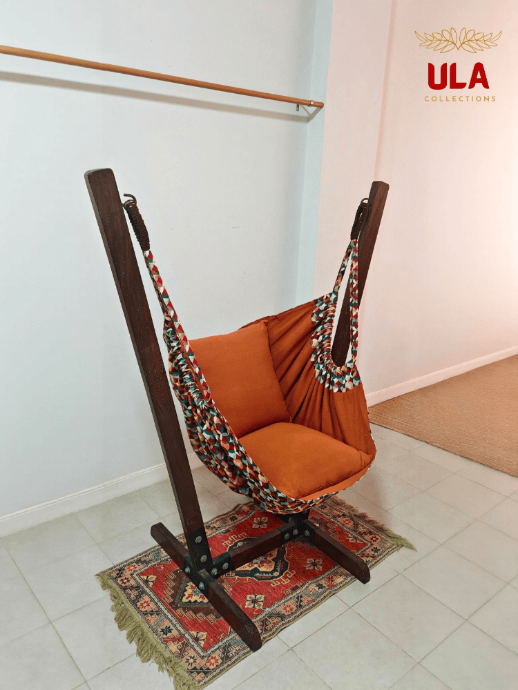 Vibrant woven fabric hammock chair featuring the Canyon multicolored overlapping circle pattern and plush orange cushions.