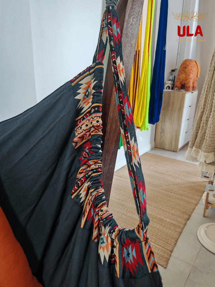 Navy and orange Native design woven hammock chair on a wooden stand