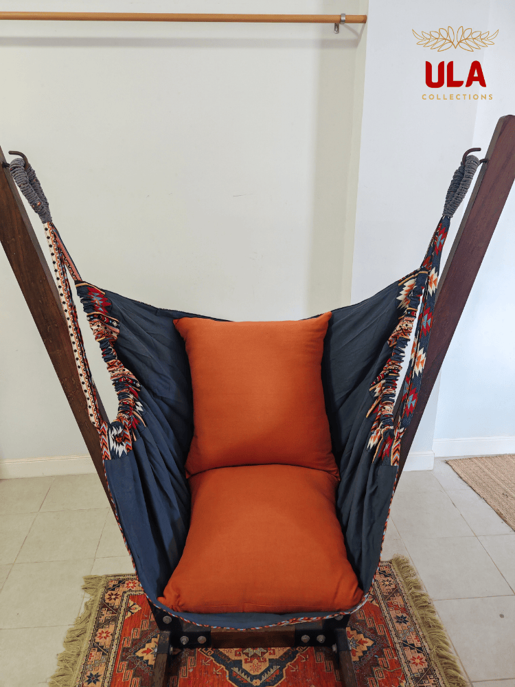 Navy and orange Native design woven hammock chair on a wooden stand