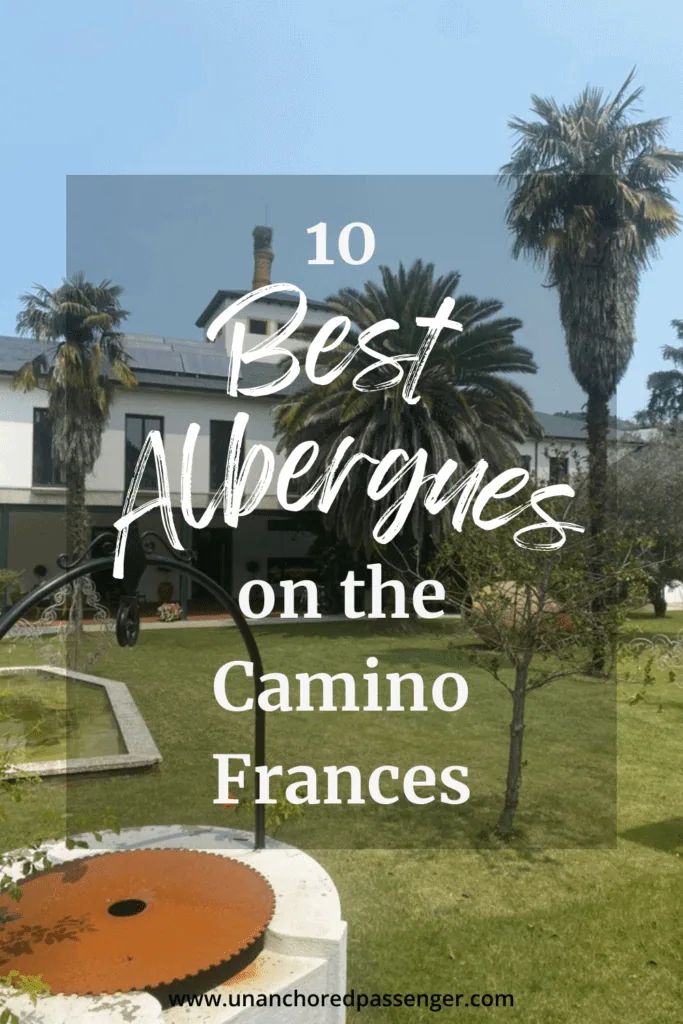 Outside of an albergue with palm trees in Villafranca del Bierzo that says "10 Best Albergues on the Camino Frances"