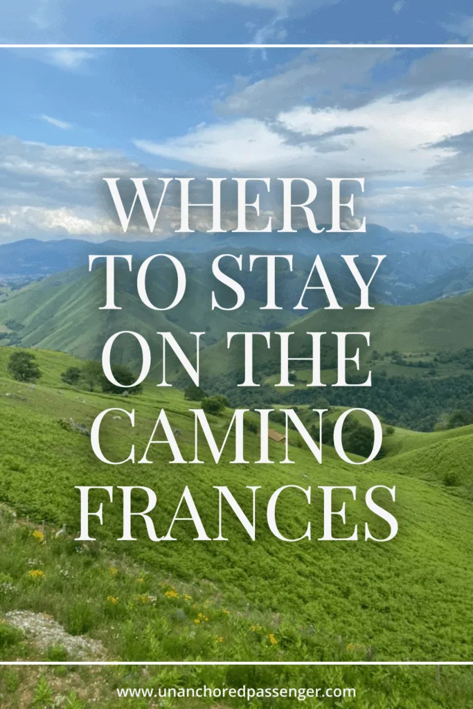 Views of the Pyrenees Mountains below on a sunny day with text that says, "Where to Stay on the Camino Frances"
