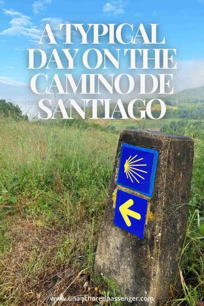 Camino de Santiago path marker pointing the way with fields and mountains behind and text that says "A Typical Day on the Camino de Santiago"