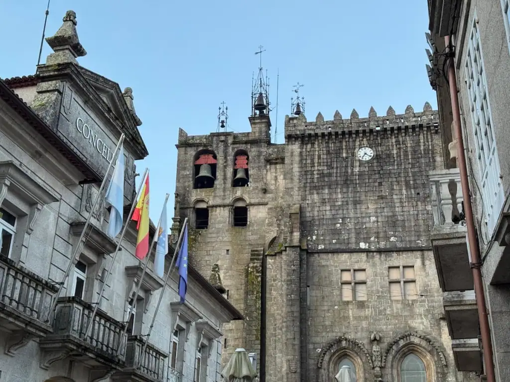 Side of the cathedral in Tui, Spain with bells in a tower.