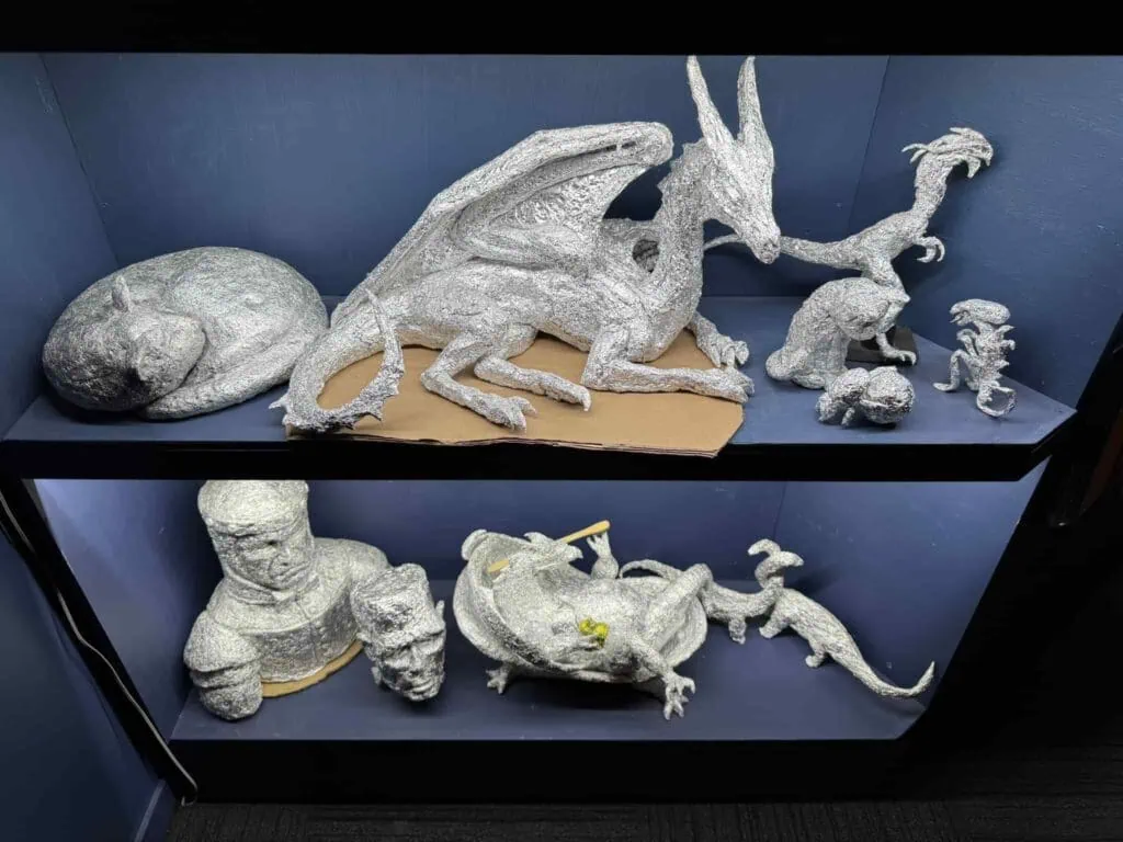 Several foil sculptures showing dragons, faces, and some other creatures at Wētā Workshop Wellington.