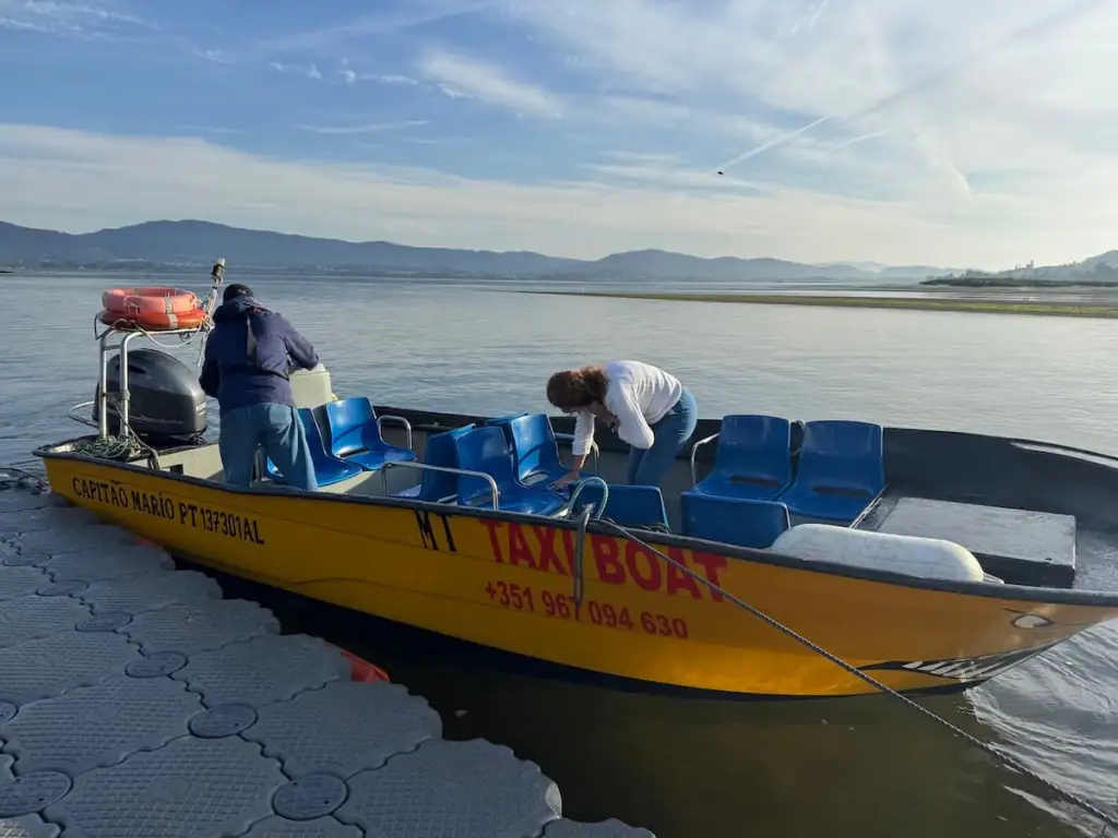 Two staff preparing a small speedboat to cross the Minho River from Portugal to Spain.