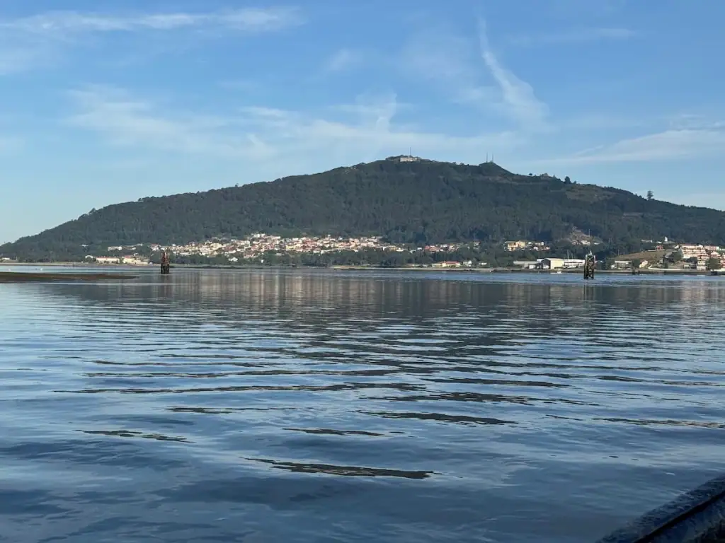 View from the ferry boat from Caminha of a small mountain and village ahead in Spain.