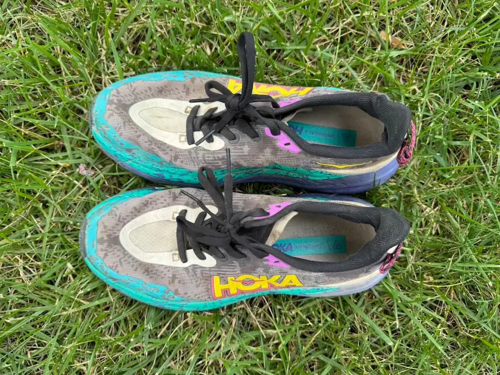 View from above of the Hoka Speedgoat 6 shoes after hiking both Camino Portugués routes. They're a bit dusty and dirty, but otherwise the uppers are in good condition.