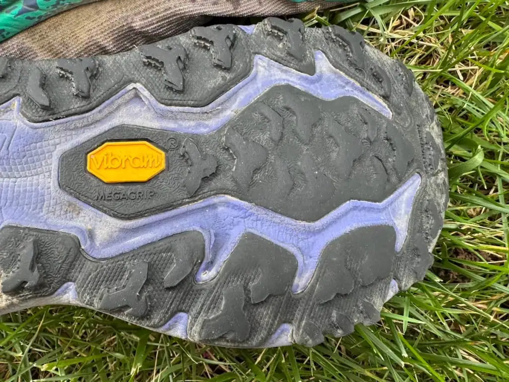Closer view of the worn down tread on a Hoka Speedgoat 6 shoe after hiking both Camino Portugués routes from Porto.