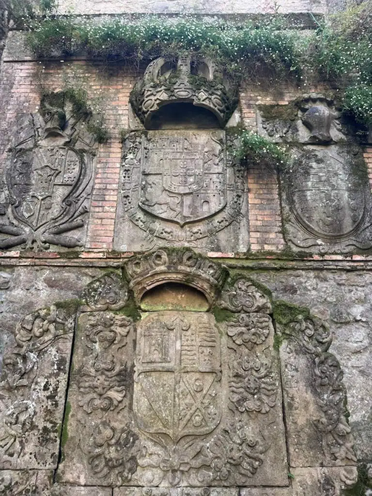 Four different coats of arms carved into stone in the Ruínas de San Domingos ruins in Pontevedra, Spain.