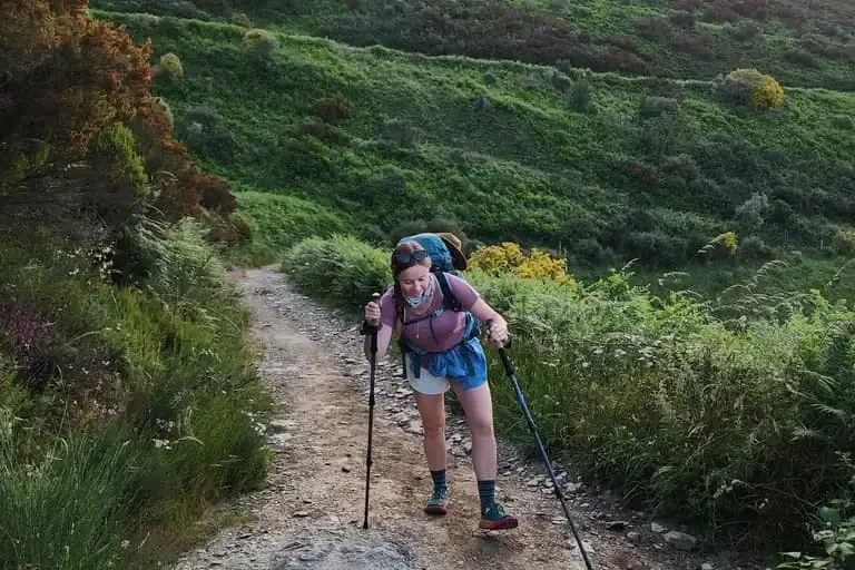 Mikala struggling up a steep mountain incline while hiking along the Camino Francés.