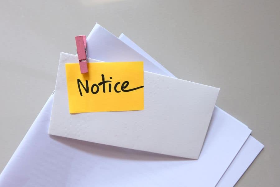 Notice letter with handwritten label clipped to envelope symbolising tenancy termination notice.