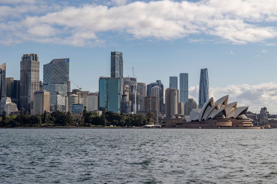 Sydney skyline with the Opera House and harbour in the foreground.