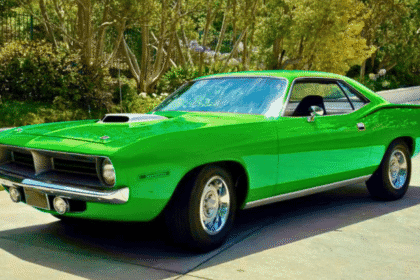 Classic muscle car restoration of a 1970 Plymouth Barracuda with vibrant red paint and chrome wheels