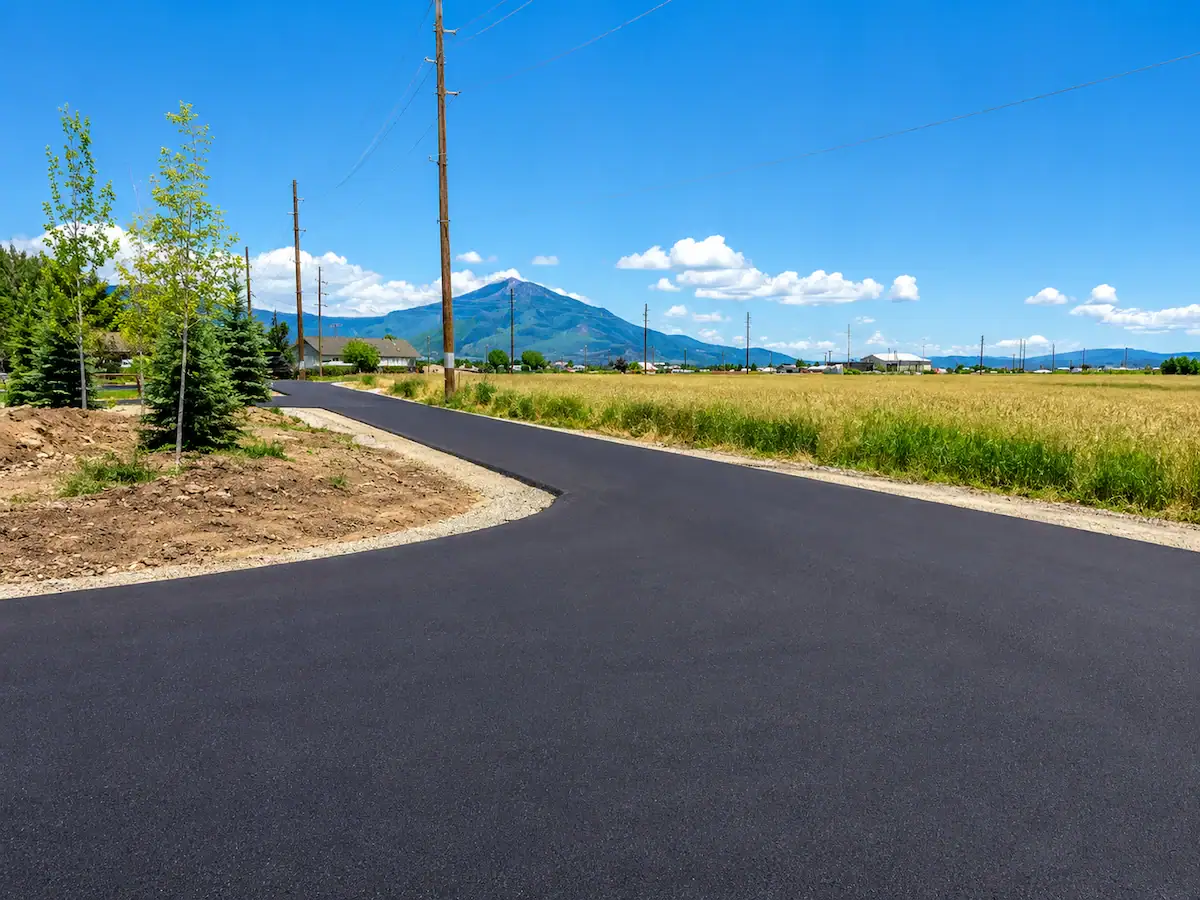 Freshly paved rural asphalt road with Utah mountain landscape