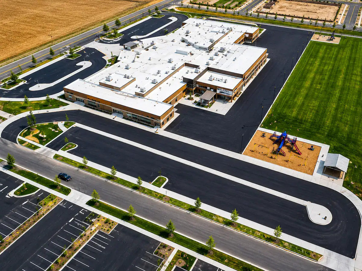 Aerial view of newly paved school parking lot and asphalt roadway in Utah